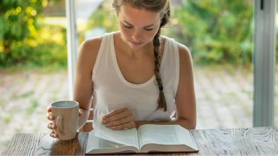 Woman studying the Bible with a cup of coffee