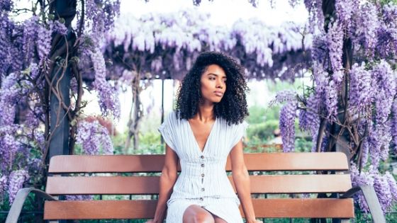 beautiful black woman sitting in her prayer garden