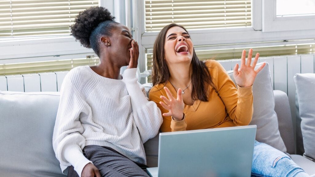 two women sitting on the couch laughing at funny Bible verses