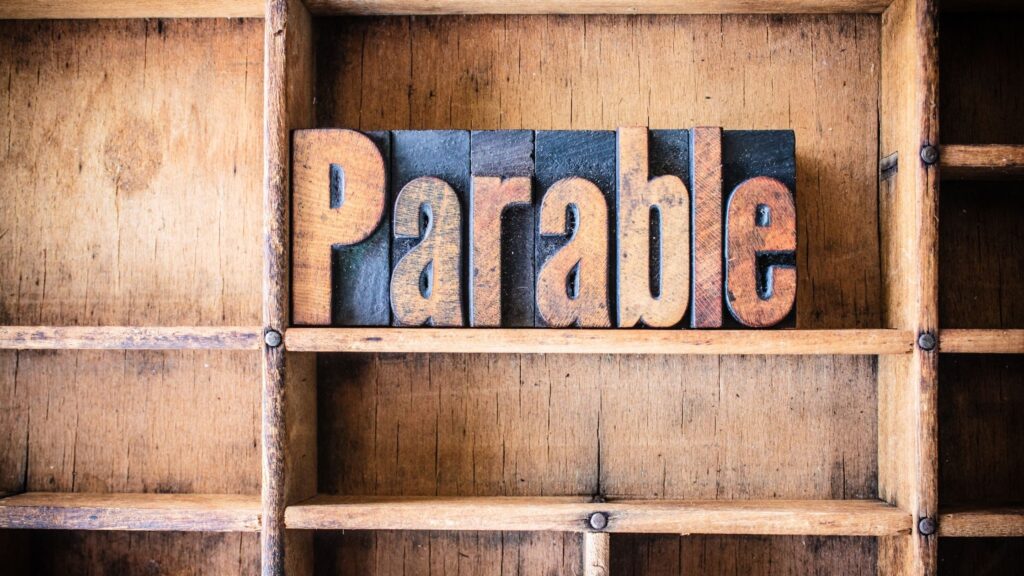 the-word-parable-cut-out-of-wood-and-sitting-inside-a-wooden-crate