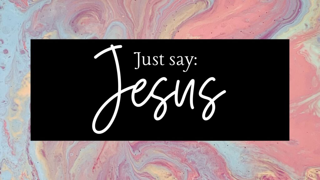 Just Say Jesus written on a black background in a marble backdrop