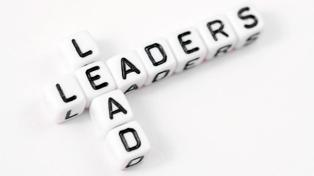 the words leaders lead spelled out with letter dice